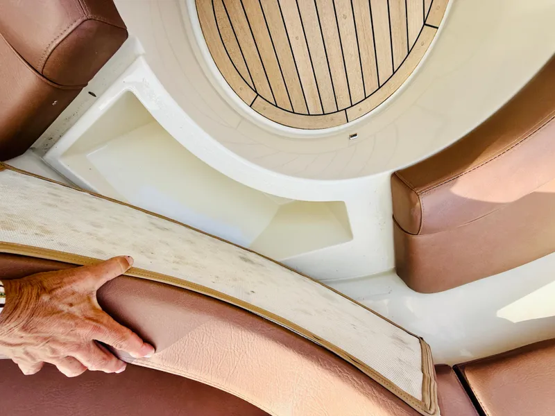 Slide: The Image of 2015 Chris-Craft Launch 32 interior with brown leather seating and wooden flooring. - 44