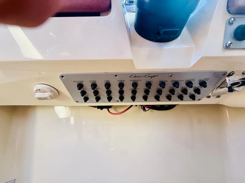 Slide: The Image of Control panel of a 2015 Chris-Craft Launch 32 boat with various switches. - 47