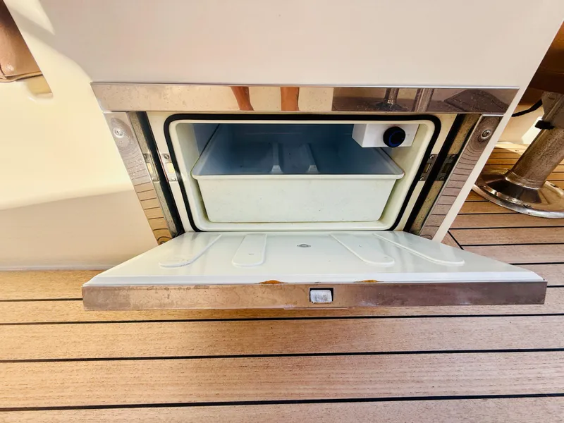 Slide: The Image of 2015 Chris-Craft Launch 32 boat cooler compartment on teak deck. - 48