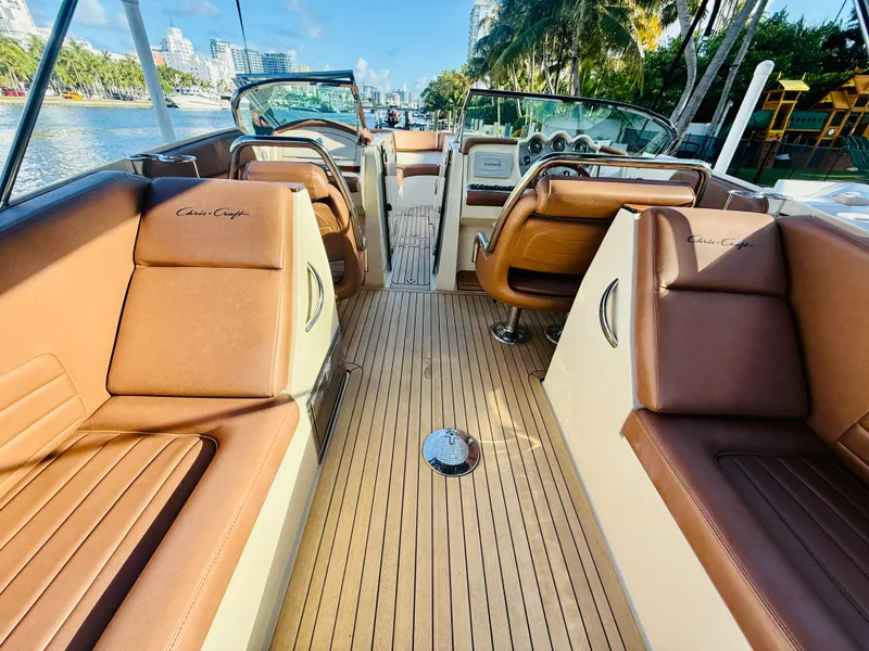 Slide: The Image of 2015 Chris-Craft Launch 32 boat interior with brown leather seats and wooden deck. - 49