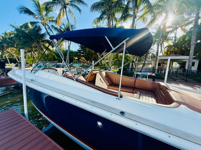 Slide: The Image of 2015 Chris-Craft Launch 32 boat docked, featuring a sleek design and luxurious seating. - 7