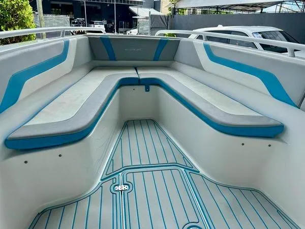 Slide: The Image of Open deck of 2019 Concept 27' boat with blue and gray seating. - 10