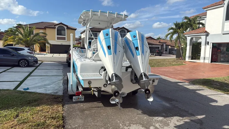 Slide: The Image of 2019 Concept 27' Open Deck boat with dual engines parked in a residential driveway. - 11