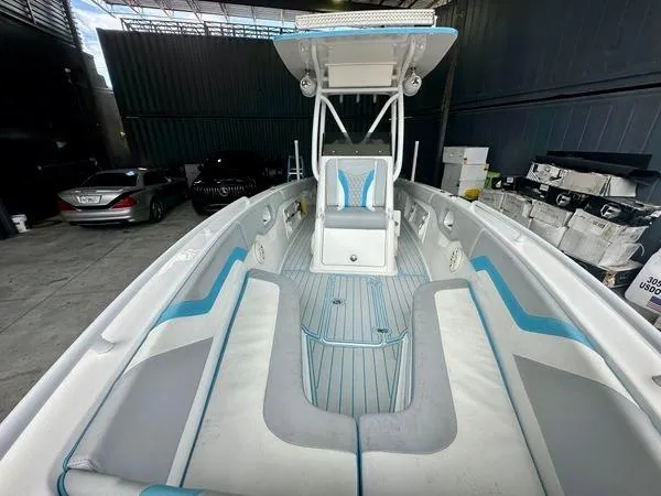 Slide: The Image of 2019 Concept 27' Open Deck boat with blue and white interior, docked in a garage. - 5