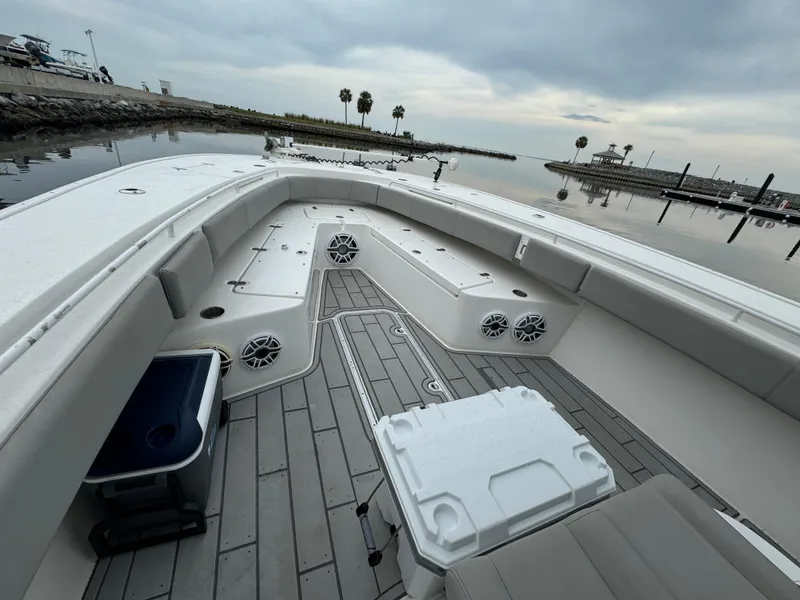 Slide: The Image of 2017 Cape Horn 36 XS boat interior with seating and storage, docked by calm waters. - 14