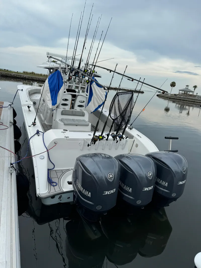 Slide: The Image of 2017 Cape Horn 36 XS boat with triple Yamaha 300 engines docked by the water. - 16