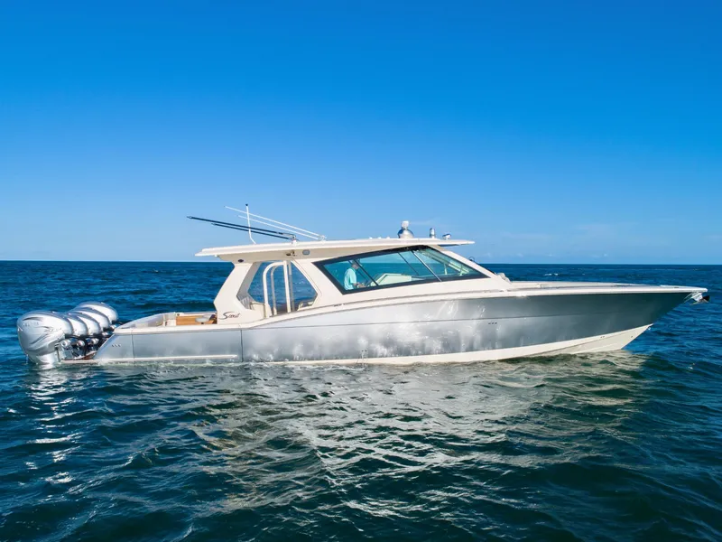 The Image of 2026 Scout 530 LXF luxury boat cruising on open water under clear blue sky. - 0