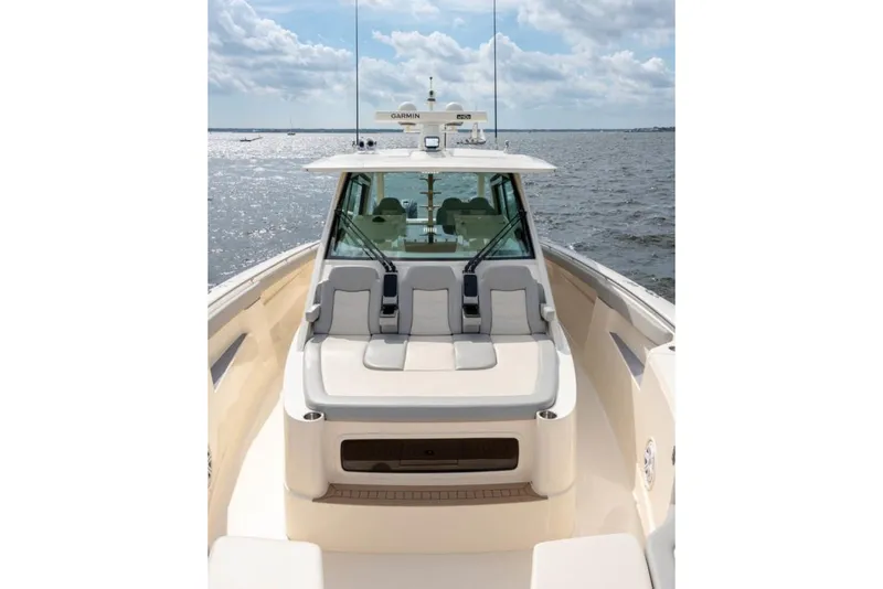 Slide: The Image of Manufacturer Provided Image: 2025 Scout 530 LXF luxury boat on open water under cloudy sky. - 12