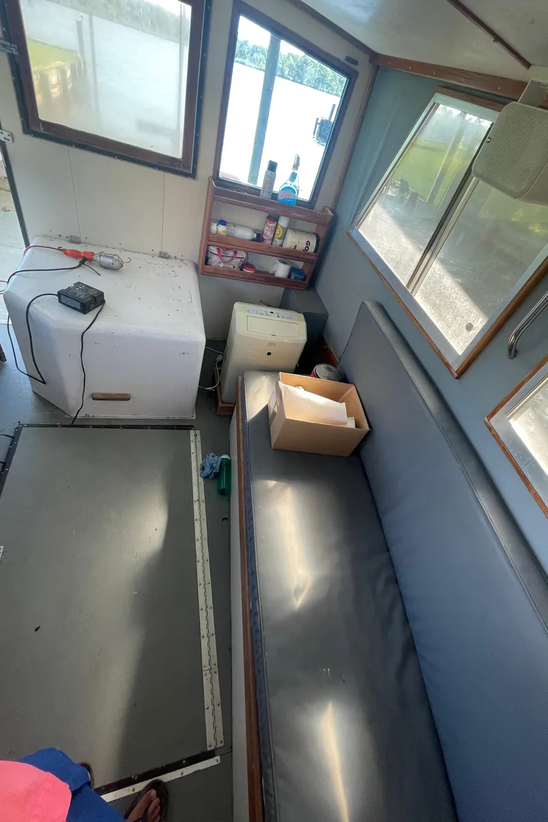 Slide: The Image of Interior of a 1995 Stuart Angler 33 Downeast boat with seating and storage. - 7