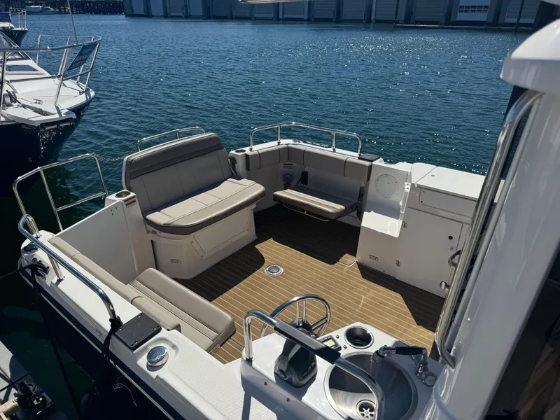 Slide: The Image of 2021 Cutwater C-28 boat interior with seating and sink, docked on calm water. - 10