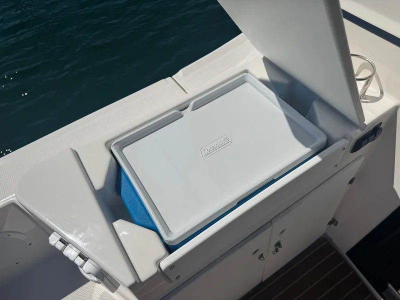 Slide: The Image of Cutwater C-28 2021 boat with Coleman cooler in storage compartment. - 12