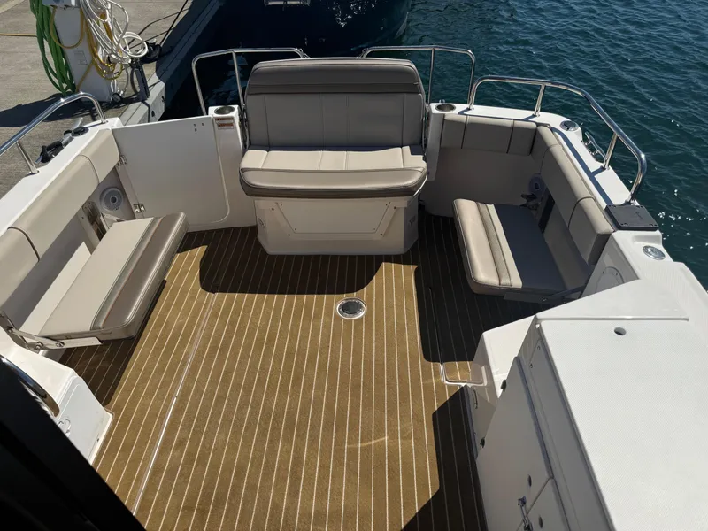 Slide: The Image of 2021 Cutwater C-28 boat deck with cushioned seating and wood-patterned flooring. - 13