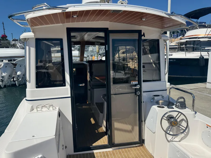 Slide: The Image of 2021 Cutwater C-28 boat with open cabin door, docked at marina. - 14