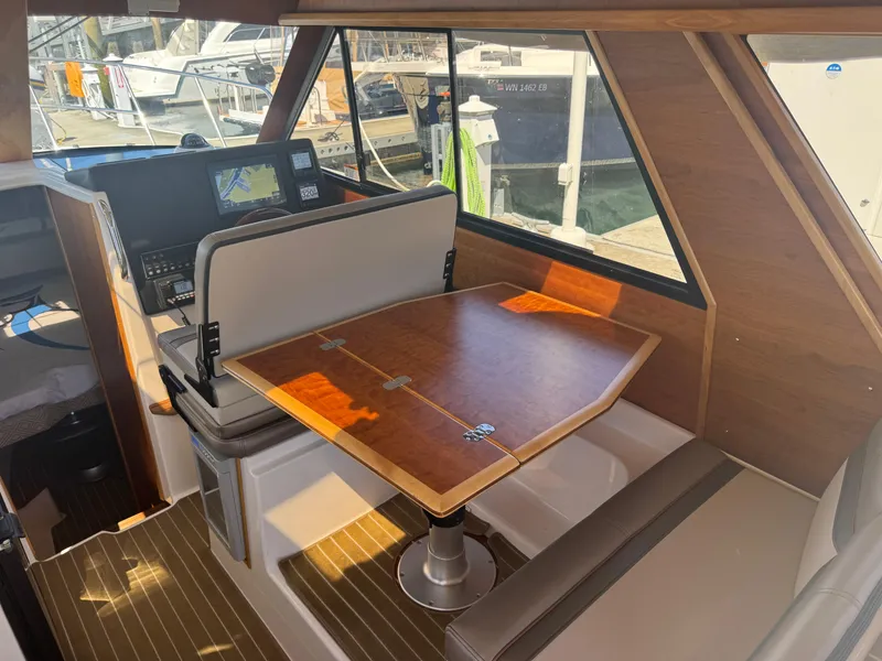 Slide: The Image of Interior of 2021 Cutwater C-28 boat with wooden table and navigation equipment. - 15