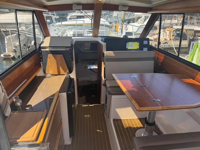 Slide: The Image of Interior of 2021 Cutwater C-28 boat with wood accents and seating area. - 18
