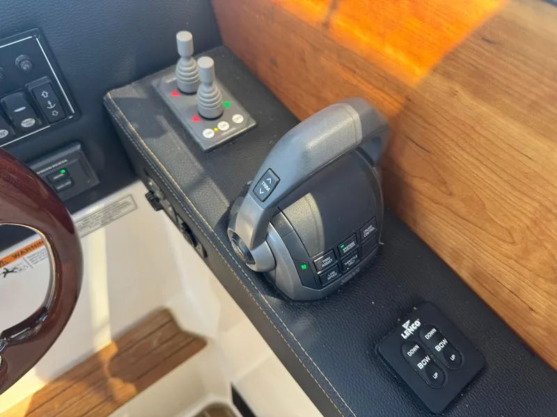 Slide: The Image of Control panel of a 2021 Cutwater C-28 boat with joystick and throttle. - 24