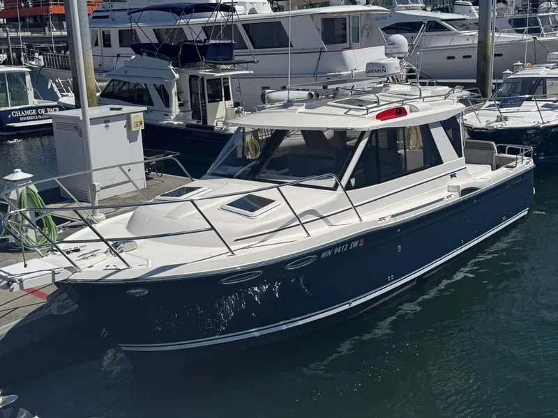 Slide: The Image of 2021 Cutwater C-28 boat docked at a marina, surrounded by other vessels. - 3
