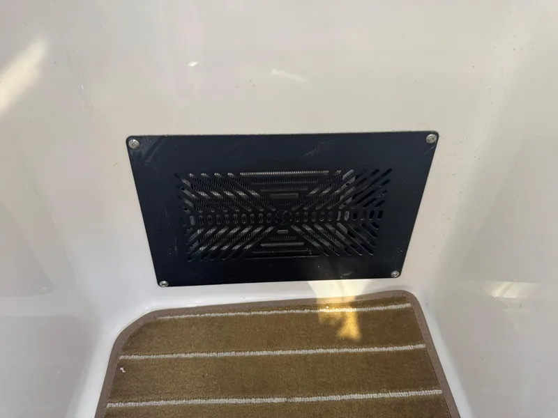 Slide: The Image of Vent panel on 2021 Cutwater C-28 boat interior with striped carpet flooring. - 32
