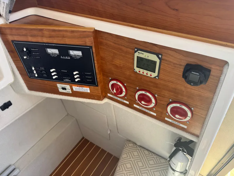 Slide: The Image of 2021 Cutwater C-28 boat control panel with switches and gauges. - 34