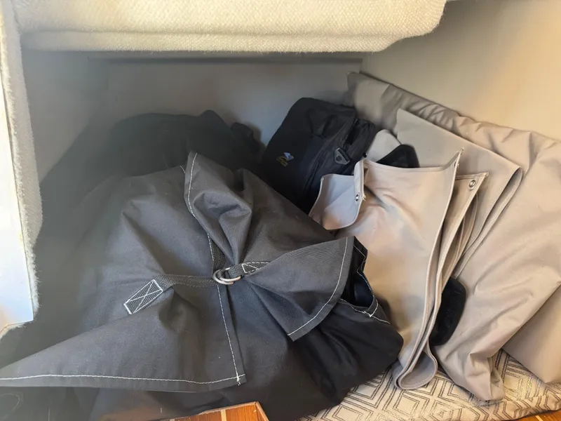 Slide: The Image of Storage compartment with folded covers in a 2021 Cutwater C-28 boat. - 35