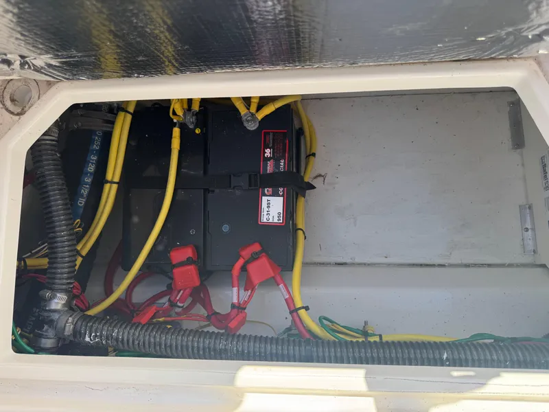 Slide: The Image of 2021 Cutwater C-28 boat battery compartment with wiring and connections. - 39
