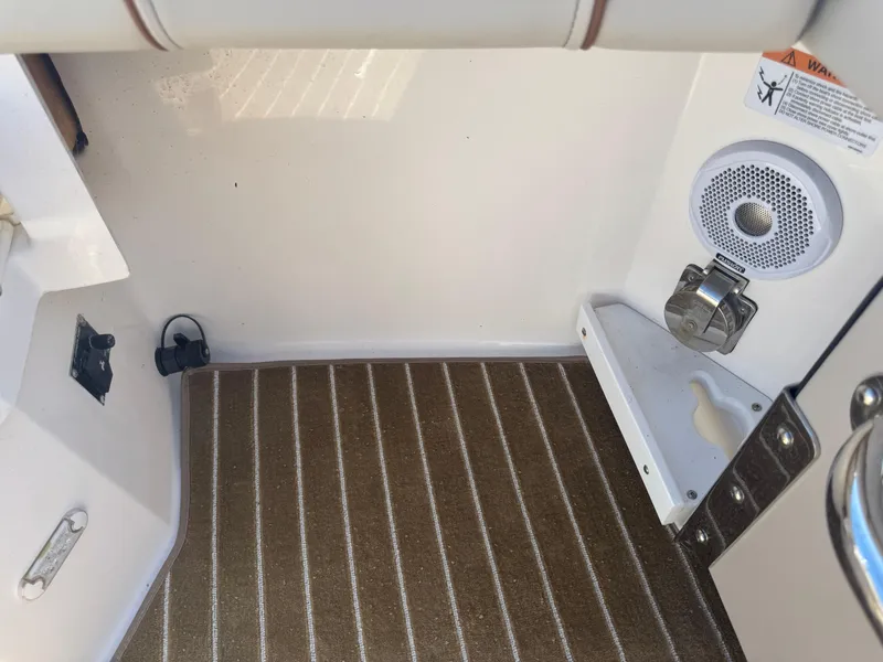 Slide: The Image of Interior of a 2021 Cutwater C-28 boat, featuring a speaker and striped flooring. - 40