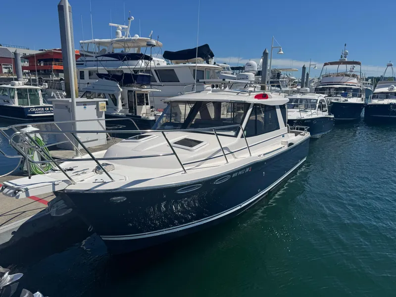 Slide: The Image of 2021 Cutwater C-28 boat docked at a marina under clear blue skies. - 5