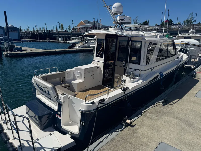Slide: The Image of 2021 Cutwater C-28 boat docked at marina under clear blue sky. - 7