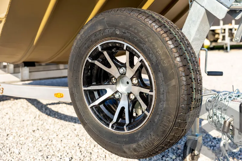 Slide: The Image of 2025 G3 Gator Tough 1652 VBW trailer wheel on gravel surface. - 10