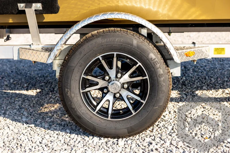 Slide: The Image of Trailer wheel of 2025 G3 Gator Tough 1652 VBW on gravel surface. - 14