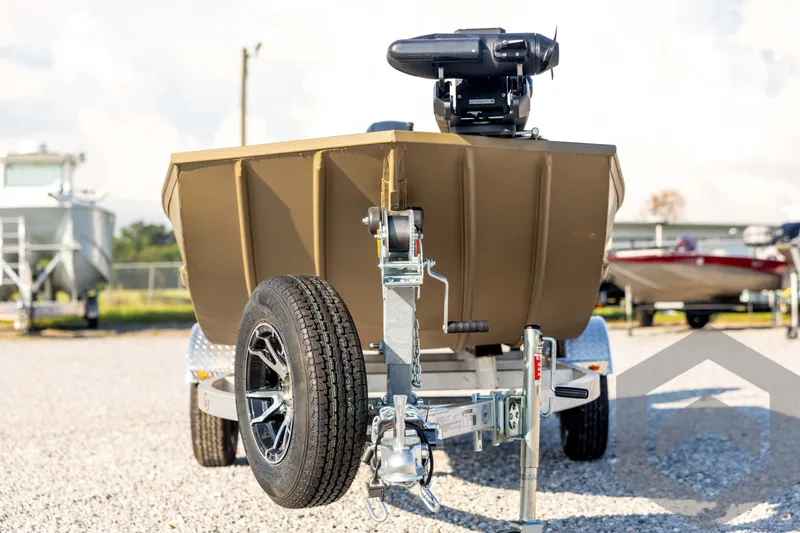 Slide: The Image of 2025 G3 Gator Tough 1652 VBW boat on trailer, parked outdoors. - 2