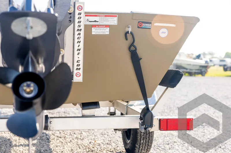 Slide: The Image of 2025 G3 Gator Tough 1652 VBW boat rear view with propeller and trailer. - 22