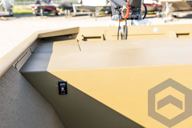 Slide: The Image of 2025 G3 Gator Tough 1652 VBW boat interior with control panel, outdoor setting. - 35