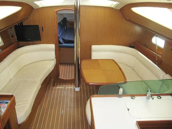 Slide: The Image of Interior of 2006 Jeanneau Sun Odyssey 42 DS yacht with elegant seating and dining area. - 13