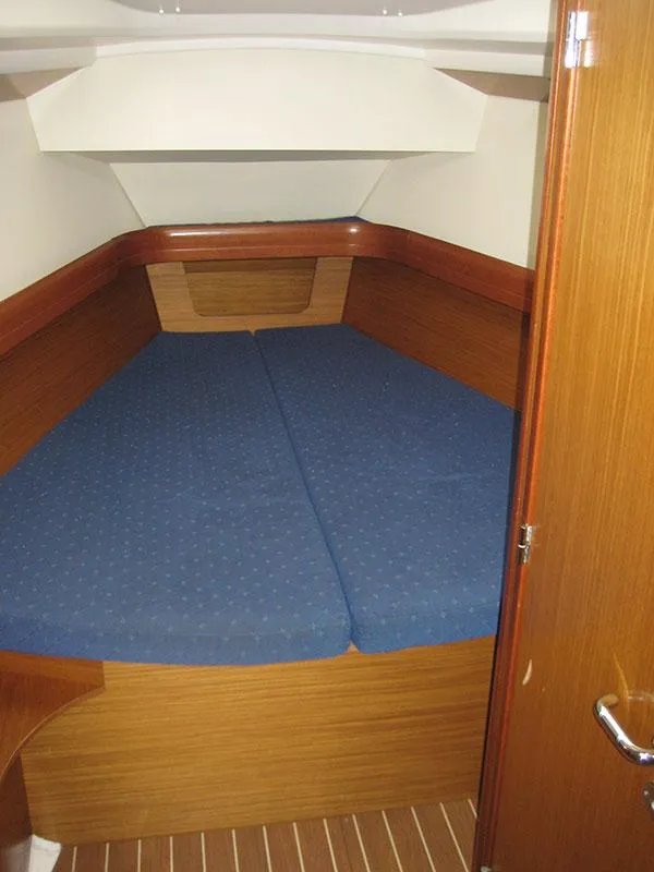 Slide: The Image of Interior cabin of 2006 Jeanneau Sun Odyssey 42 DS with blue bedding. - 16