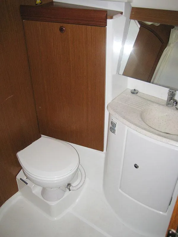 Slide: The Image of Bathroom interior of 2006 Jeanneau Sun Odyssey 42 DS yacht, featuring toilet and sink. - 2