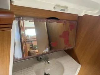 Slide: The Image of Interior of 2006 Jeanneau Sun Odyssey 42 DS yacht, featuring a bathroom sink and mirror. - 23