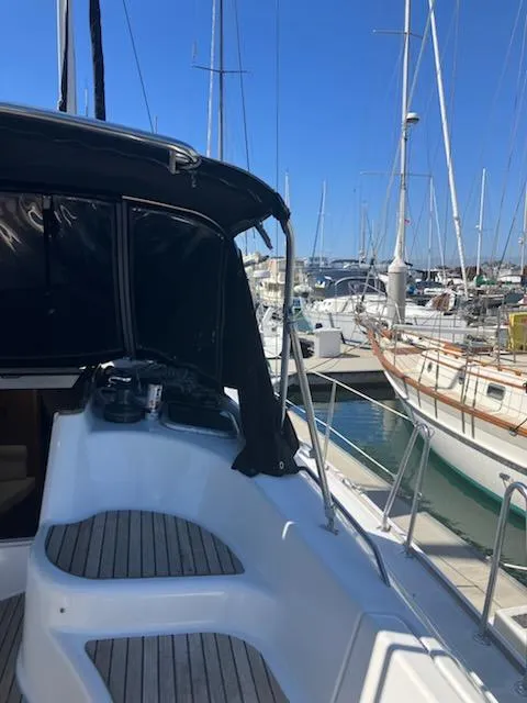 Slide: The Image of 2006 Jeanneau Sun Odyssey 42 DS sailboat docked in a marina, featuring sleek design. - 24