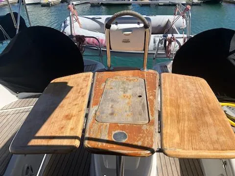 Slide: The Image of Cockpit of 2006 Jeanneau Sun Odyssey 42 DS with wooden table and steering wheel. - 4
