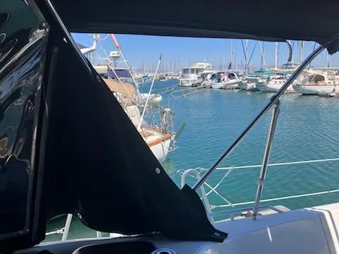 Slide: The Image of Jeanneau Sun Odyssey 42 DS sailboat, 2006 model, docked in a marina with clear blue water. - 6