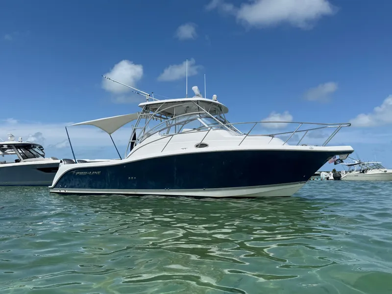 Slide: The Image of 2008 Pro-Line 32 Express boat on clear water under blue sky. - 1