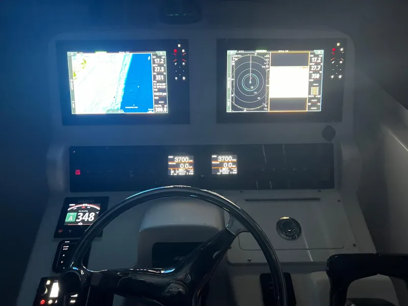 Slide: The Image of 2008 Pro-Line 32 Express boat dashboard with navigation screens and controls. - 12