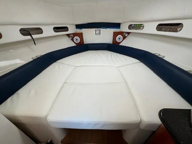 Slide: The Image of 2008 Pro-Line 32 Express cabin interior with white and blue seating, speakers, and storage compartments. - 14