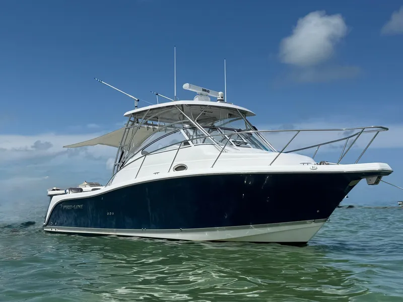 Slide: The Image of 2008 Pro-Line 32 Express boat on calm water under clear blue sky. - 3