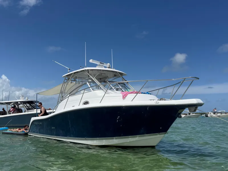 Slide: The Image of 2008 Pro-Line 32 Express boat anchored in clear water under a blue sky. - 4