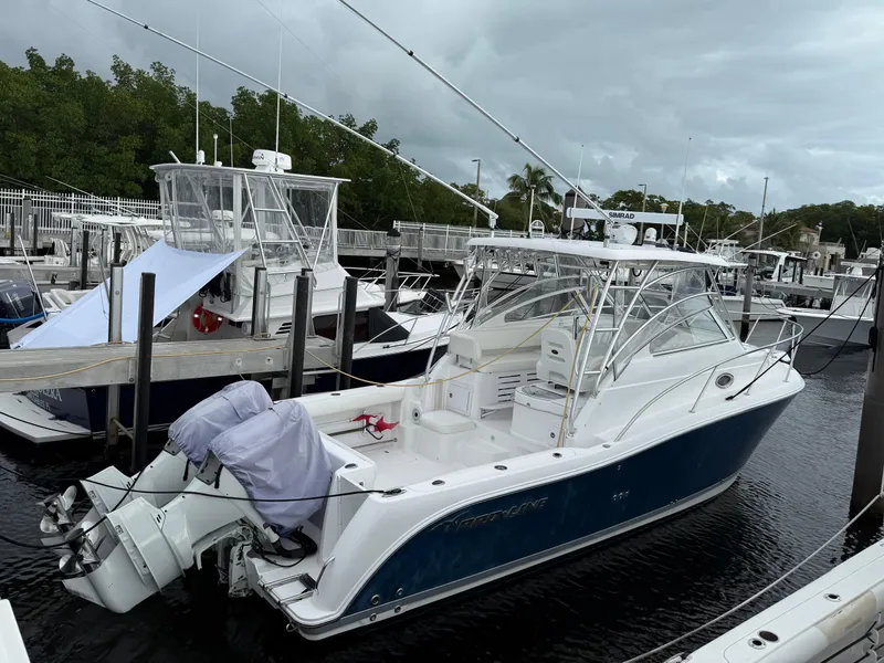 Slide: The Image of 2008 Pro-Line 32 Express boat docked at marina, featuring sleek design and dual outboard engines. - 5