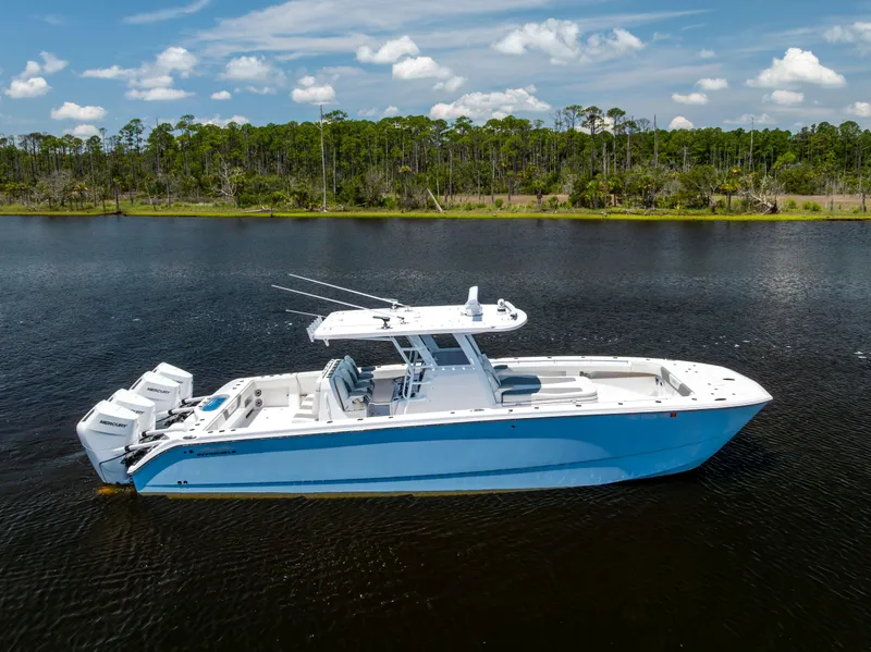 Slide: The Image of 2024 Invincible 37 Catamaran on calm water, showcasing sleek design and powerful engines. - 10