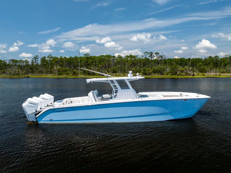 Slide: The Image of 2024 Invincible 37 Catamaran on calm water, clear sky background. - 11