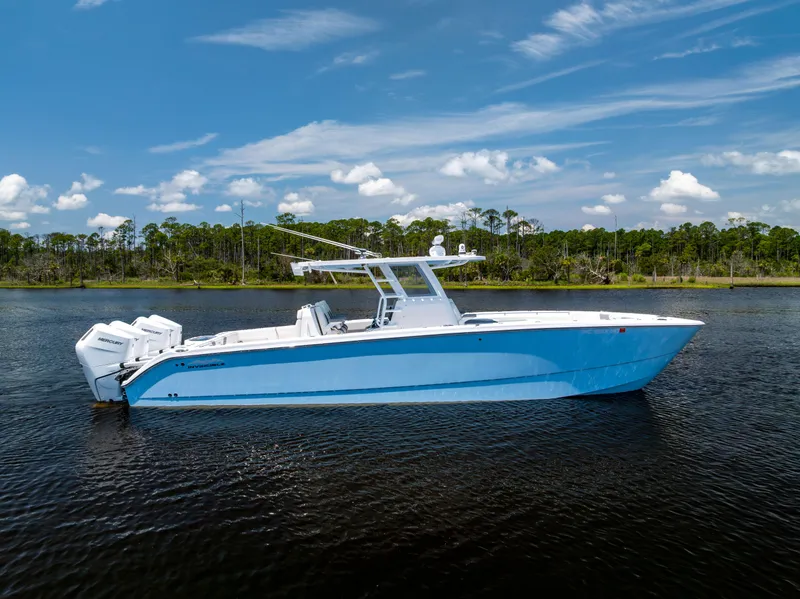 Slide: The Image of 2024 Invincible 37 Catamaran on calm water, showcasing sleek design and powerful engines. - 12