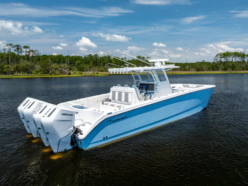 Slide: The Image of 2024 Invincible 37 Catamaran with triple Mercury engines on calm water. - 13